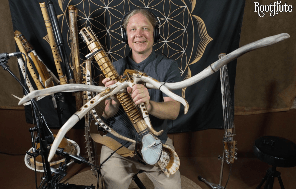 Daniel in the studio, headphones on, surrounded by handcrafted flutes and instruments